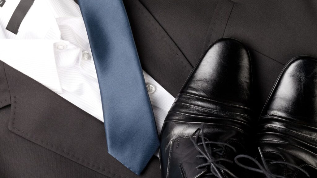 men's suit with blue tie, white button down, and polished, black dress shoes